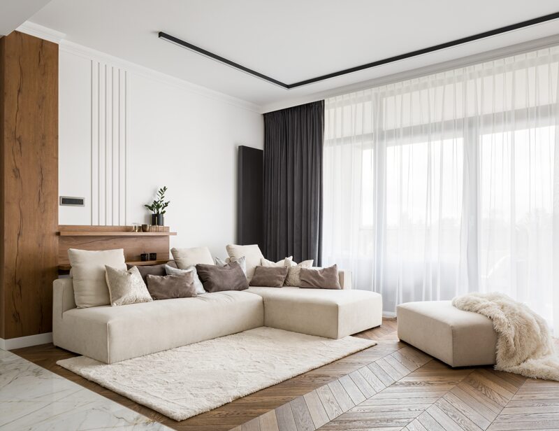 Light-filled living room with a soft neutral palette and warm wood details